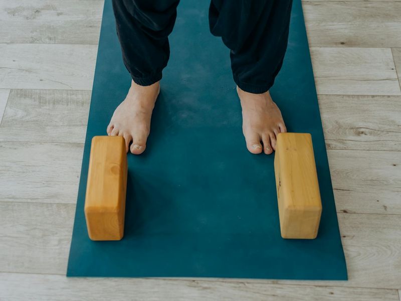 Yoga mat and blocks in a minimalist dark room